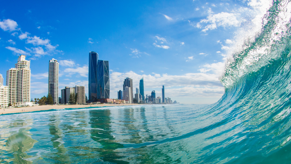 gold-coast-beach-with-wave-and-buildings