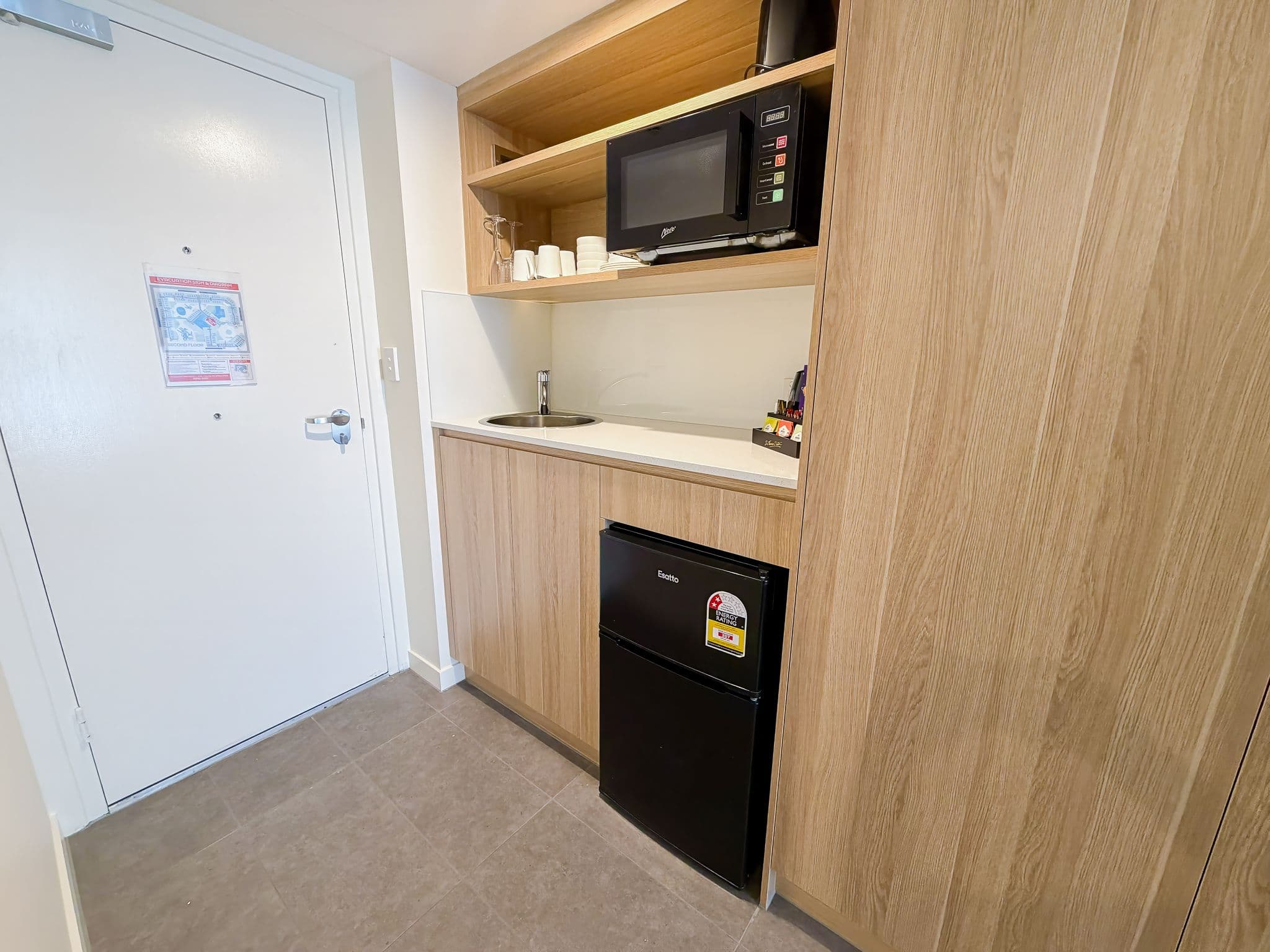 In-room kitchenette with a microwave, bar fridge, tea and coffee facilities