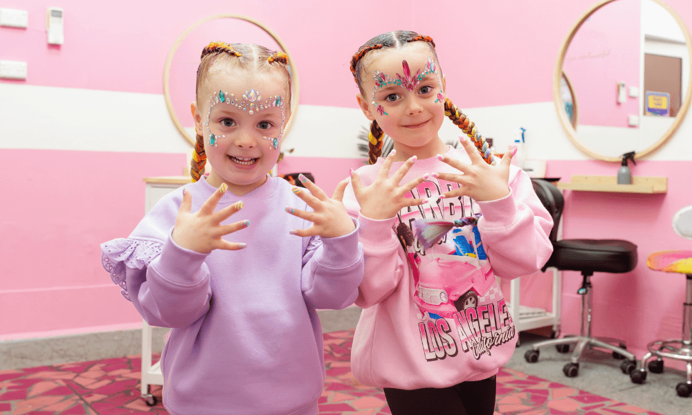 Girls with hair braiding and face jewels and Paradise Resort's Pamper Parlour