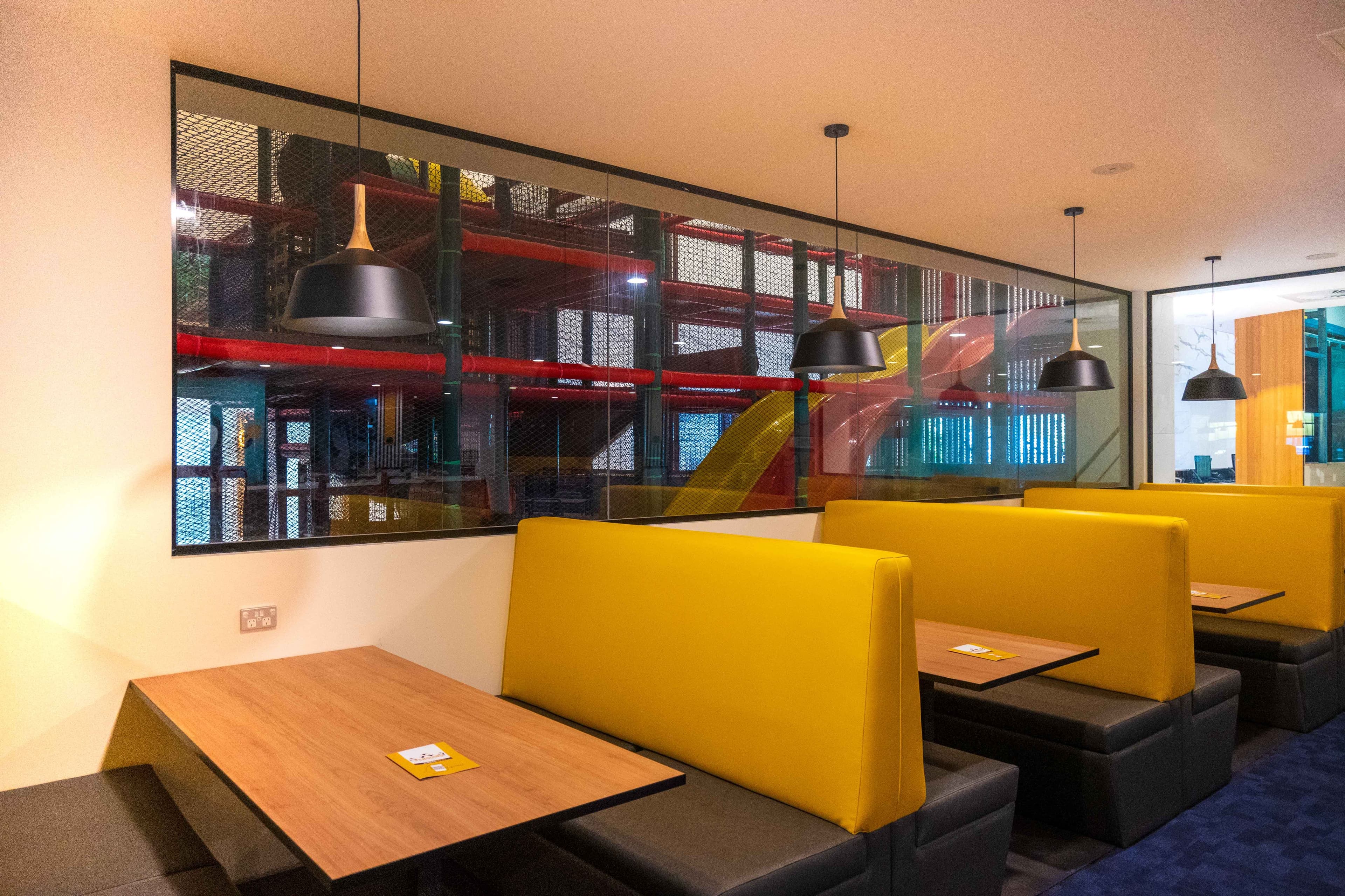 Booth seating overlooking the Jungle Gym located in the Lobby