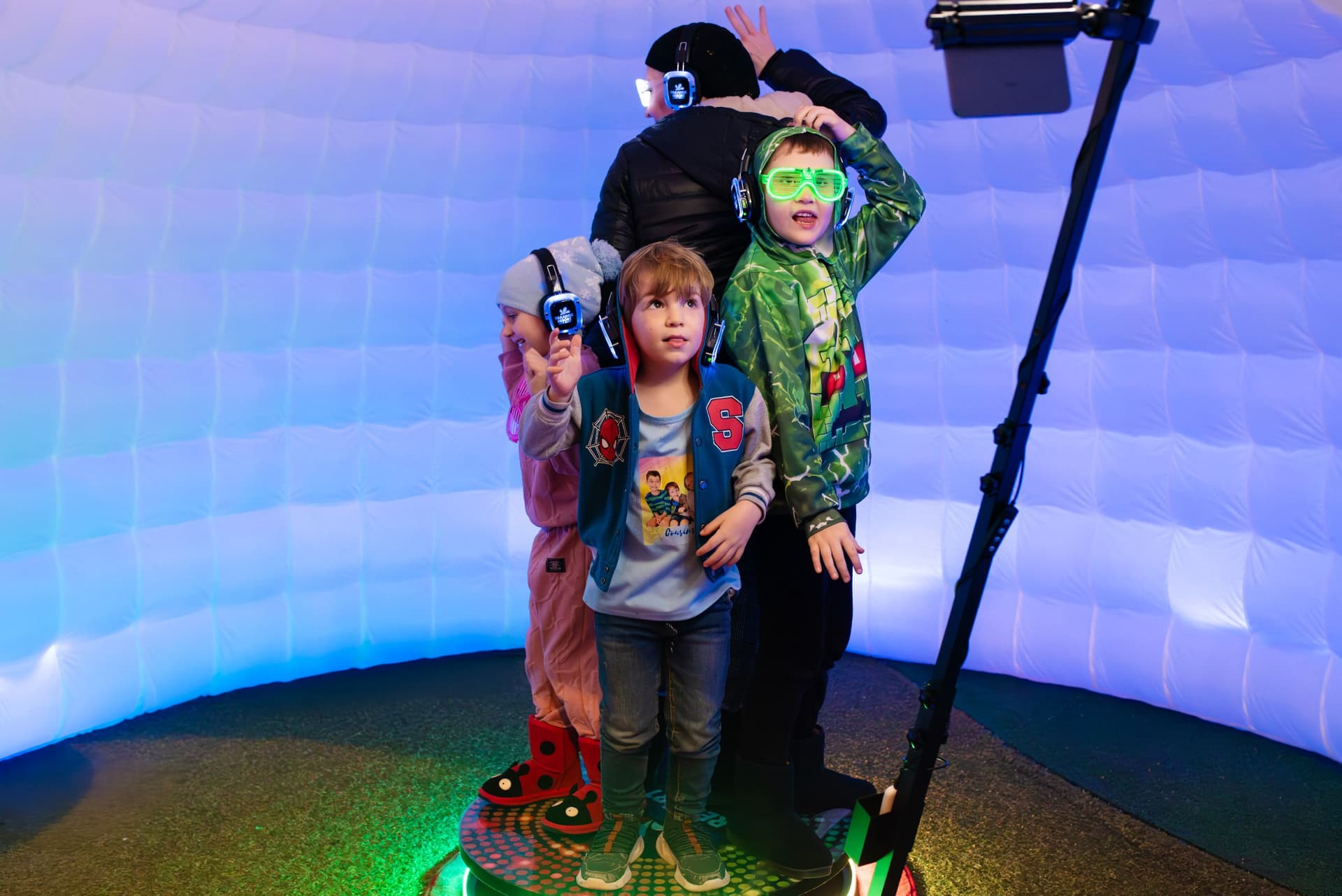 Family on the 360 photo booth wearing LED glasses