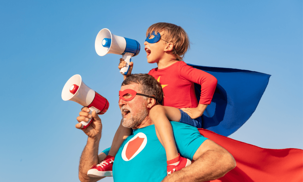 Dad and son in superhero costumes