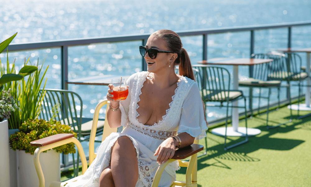 Woman holding a cocktail on board a cruise